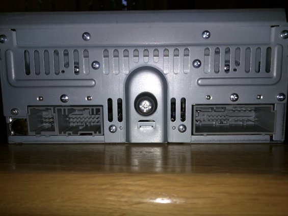 Rear view of car stereo with two multi-pin connectors and ventilation slots