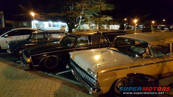 Cream-colored 1959 station wagon with chrome grille and side trim, parked at night