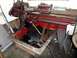 1969 Lincoln Continental - A red metal lathe, likely an industrial machine, is shown with various tools and parts stored in a metal bin below.