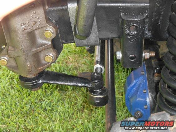 Close-up of steering linkage and blue suspension component