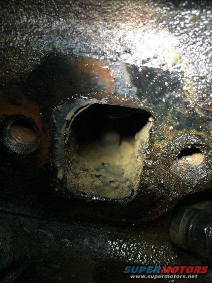 image_27.jpeg here is more rust in the exhaust port and more of the flaky stuff in the bottom of the port.