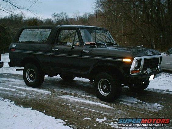 1978 Ford Bronco parked on a wet, snowy road