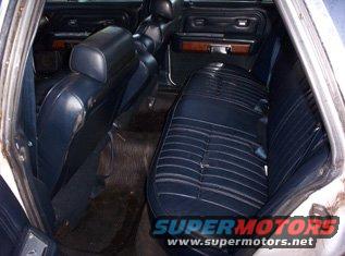 Blue vinyl interior of a sedan, rear seats visible. Watermark reads SUPERMOTORS