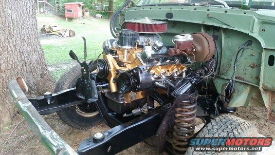 Engine bay with gold-painted V8 engine and red air filter