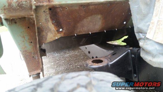 Rusted vehicle frame and tire with Supermotors.net watermark