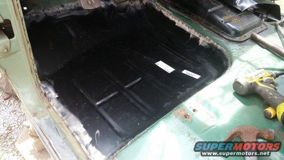 1978 Ford Bronco interior floor pan with black coating and some rust