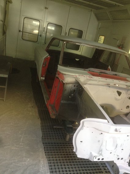 1964 Ford Fairlane body in paint booth, front quarter view