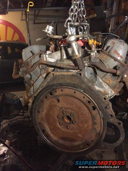 c43e194408cf403babde0399a73f5b01.jpg here you can see the back of the motor.  i believe i damaged the crossover tube when i was disconnecting the wiring harness.  i'm going to reuse the flex plate since the new (used) motor had a e4od transmission and im pretty sure the c6 and e4od use a different flex plate.