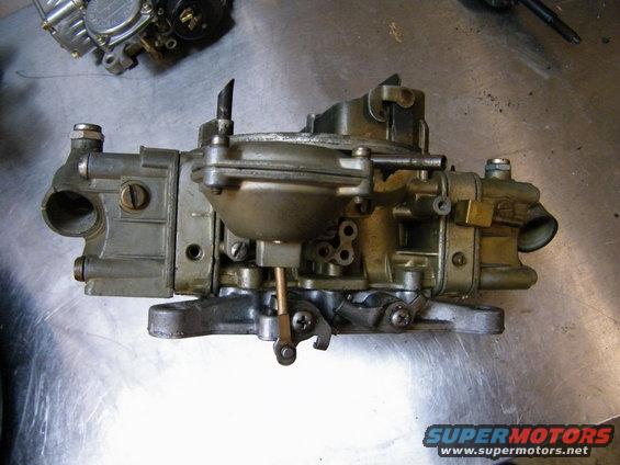 Holley carburetor on a metal surface. Another carburetor is partially visible in the background