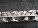 1971 Ford Ranchero - Close-up view of an aluminum engine cylinder head, brass inserts for valve guides.