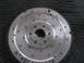 1971 Ford Ranchero - A metal flywheel, possibly for a Ford Ranchero, is shown with visible bolt holes and engraved text.