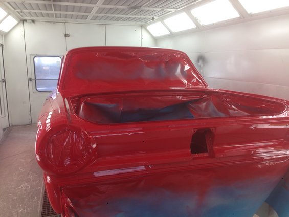 1964 Ford Fairlane rear in paint booth, covered in plastic