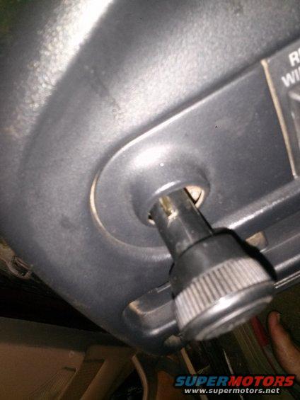 Dashboard knob with ribbed grip and visible shaft