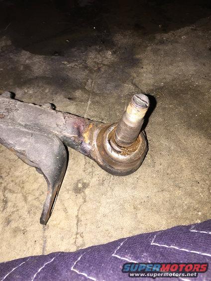 Close-up of a worn ball joint attached to a control arm
