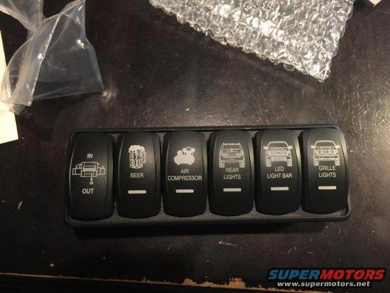 Rocker switch panel with icons for winch, beer, air compressor, rear lights, LED light bar, and grille lights