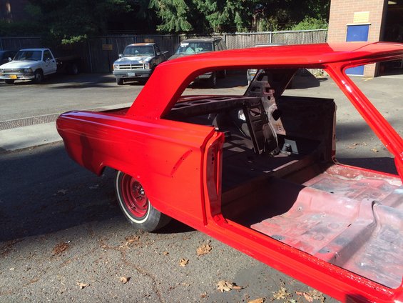 1964 Ford Fairlane body, red, stripped down, open doors, parked outside with other vehicles