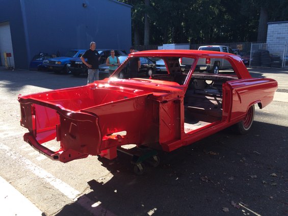 1964 Ford Fairlane body, painted red, with doors and hood removed, on a dolly