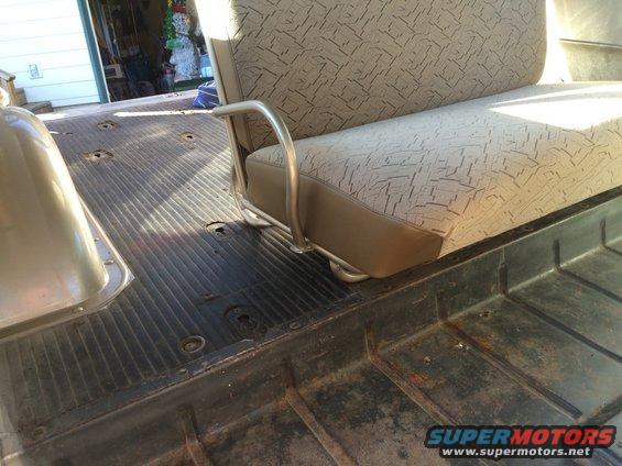 Interior shot of a vehicle's rear bench seat and ribbed floor