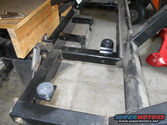 Vehicle frame with wooden support and visible hardware