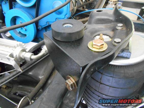 Engine part with blue pulley and black rubber mount