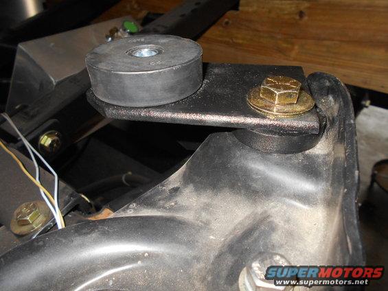 Rubber body mount with bolt and washer on metal bracket