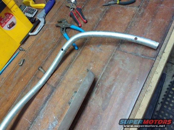 Then I drilled holes in the bent pipe to hook to the step bar.