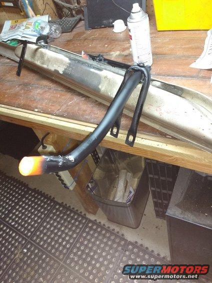 Forgot to take a picture during the work but I cut off one of the original U support pipes and bolted it into my pipe for a little extra support it needed.

Then I gave it a couple coats of Rustoleum black to help protect a little from rust. I filled all the holes with some strong silicone adhesive to stop dirt and water from getting in the piping the best I could.