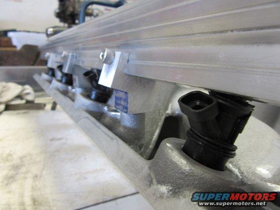 Close-up of fuel injectors on an aluminum intake manifold