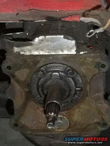 Close-up of a vehicle's transmission housing with a splined shaft protruding
