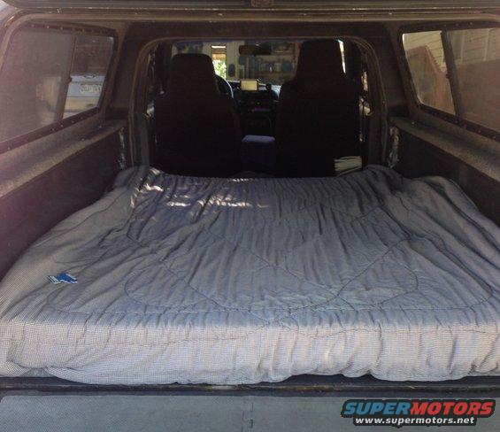 Interior of truck bed with sleeping bag covering the entire area