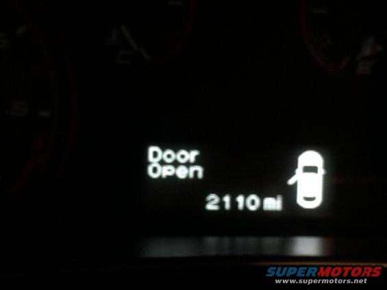 Gauges and digital display in a car interior at night