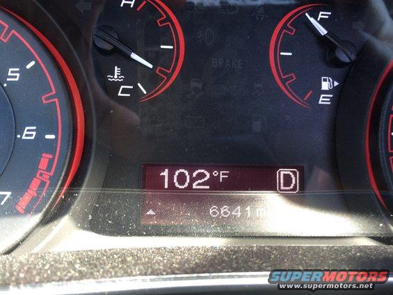 Car dashboard showing temperature at 102°F and 6641 miles. Gear selector is in 'D'