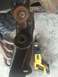 1978 Ford Bronco - Close-up of heavily rusted vehicle suspension components next to a yellow DeWalt reciprocating saw.