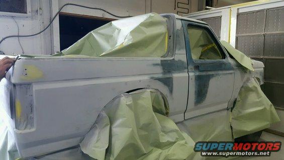 1988 Ford Bronco bodywork in primer, covered in masking paper for paint prep