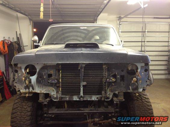 1988 Ford Bronco front end with grille removed, hood scoop, and missing headlights