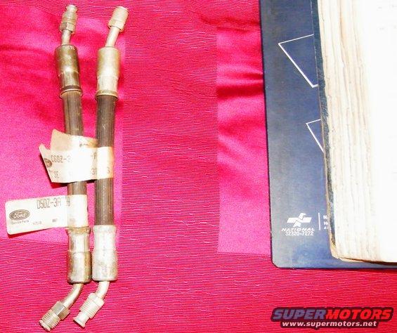Two Ford brake hoses with part number labels