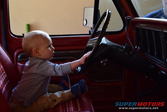 Child at the wheel of a 1978 Ford Bronco interior