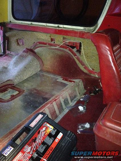Interior view of a vehicle with red seats and a Craftsman tool set on the floor