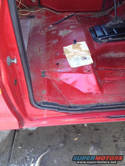 Red interior floor with a paper document taped to it