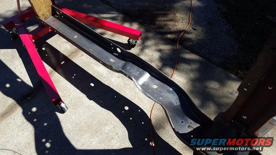 Vehicle frame section on red engine stand outdoors