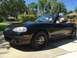 2001 Mazda Miata - This black 2001 Mazda Miata convertible is shown from the front three-quarter view.