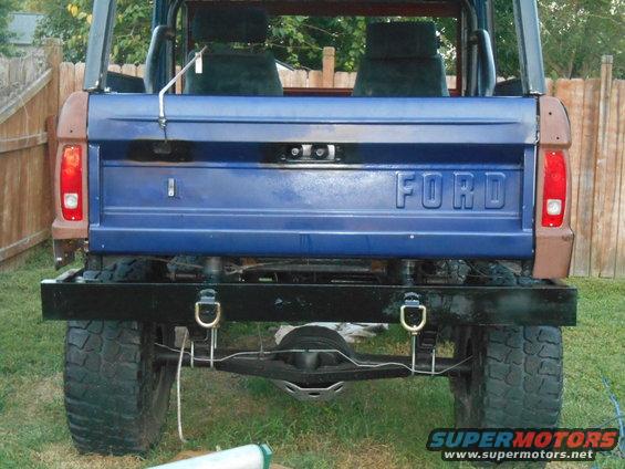 Rear view of blue 1972 Ford Bronco with black bumper and "FORD" tailgate