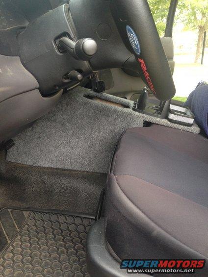 2001 Ford Ranger interior showing steering wheel with Ford logo, floor mats, and part of a seat