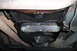 1990 Ford Bronco - Underside view of a vehicle's engine and exhaust system, with visible oil pan and pipes.