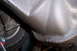 1990 Ford Bronco - Close-up view of the vehicle's undercarriage, with a tire visible on a jack.