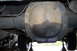 1990 Ford Bronco - Underside view of a vehicle's rear differential showing signs of an oil leak.