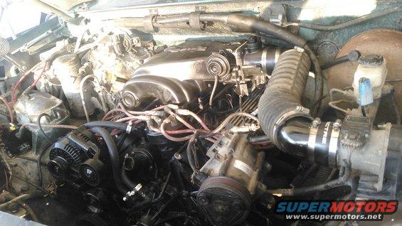 went ahead and started final assembly. even got it test fired and it started right up. i forogt to bypass the tranny cooler so it spewed alot of ATF on the ground so i shut it off after a few seconds.

got the intake and throttle body mounted. i mounted the intake facing the opposite way than its designed which i felt would be best to clear the A/C box and be easier to mount to the air filter housing. i used a 3/8" phenolic  intake spacer instead of the 1" spacer due to clearance issues with the firewall and wiper motor

i am using a 200amp alternator with 6 guage wire. i replaced the saginaw power steering pump with a new one. 

i reused my flexible intake tube and used a 90* and a 45* Spectre intake elbow to connect to the intake box. currently i am still using the stock MAF sensor but it will probably soon be replaced with a calibrated MAF for 75mm housing and 42lb injectors
