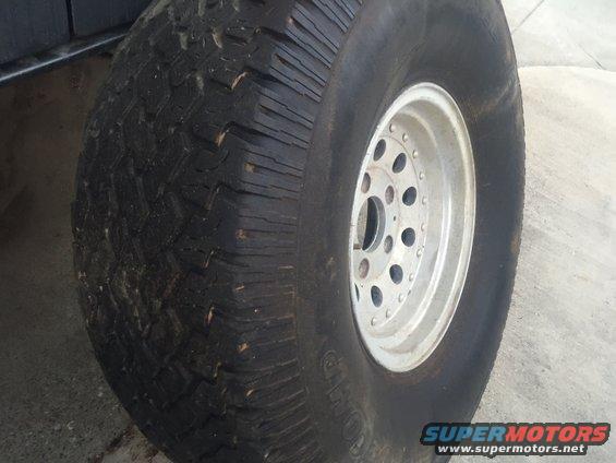 Close-up of a large off-road tire on a silver multi-hole wheel
