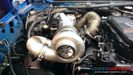 Engine with large turbocharger and exhaust manifold