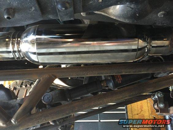 Chrome exhaust pipe and suspension parts under a vehicle